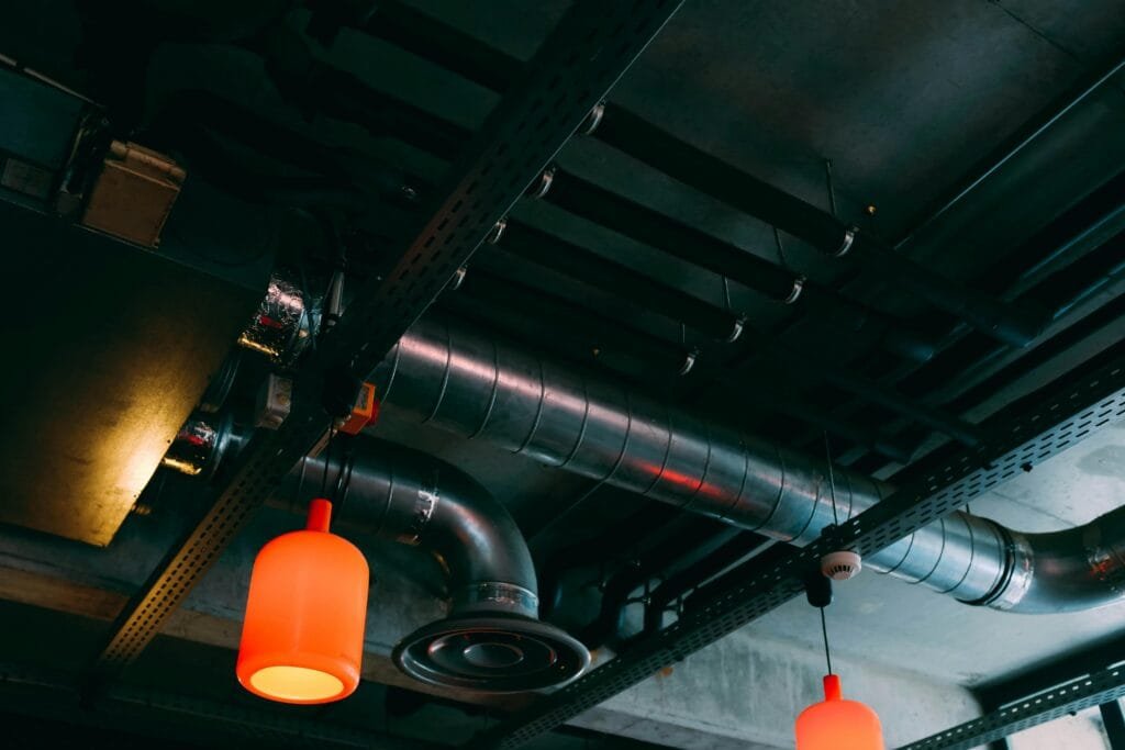 Exposed ductwork and pendant lights on a dark ceiling - ENERGY STAR certification in Hudson, MA