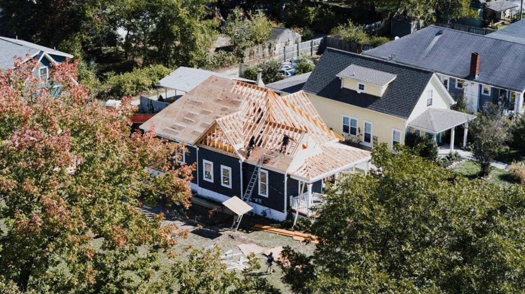 Aerial view of a neighborhood of dark-roofed houses among trees - ENERGY STAR certification in Beverly, MA