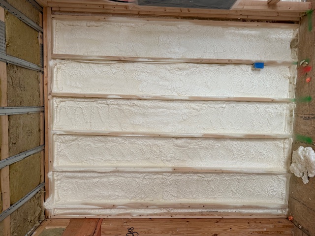 Closed-cell spray foam insulation applied to wall framing in Barnstable, MA