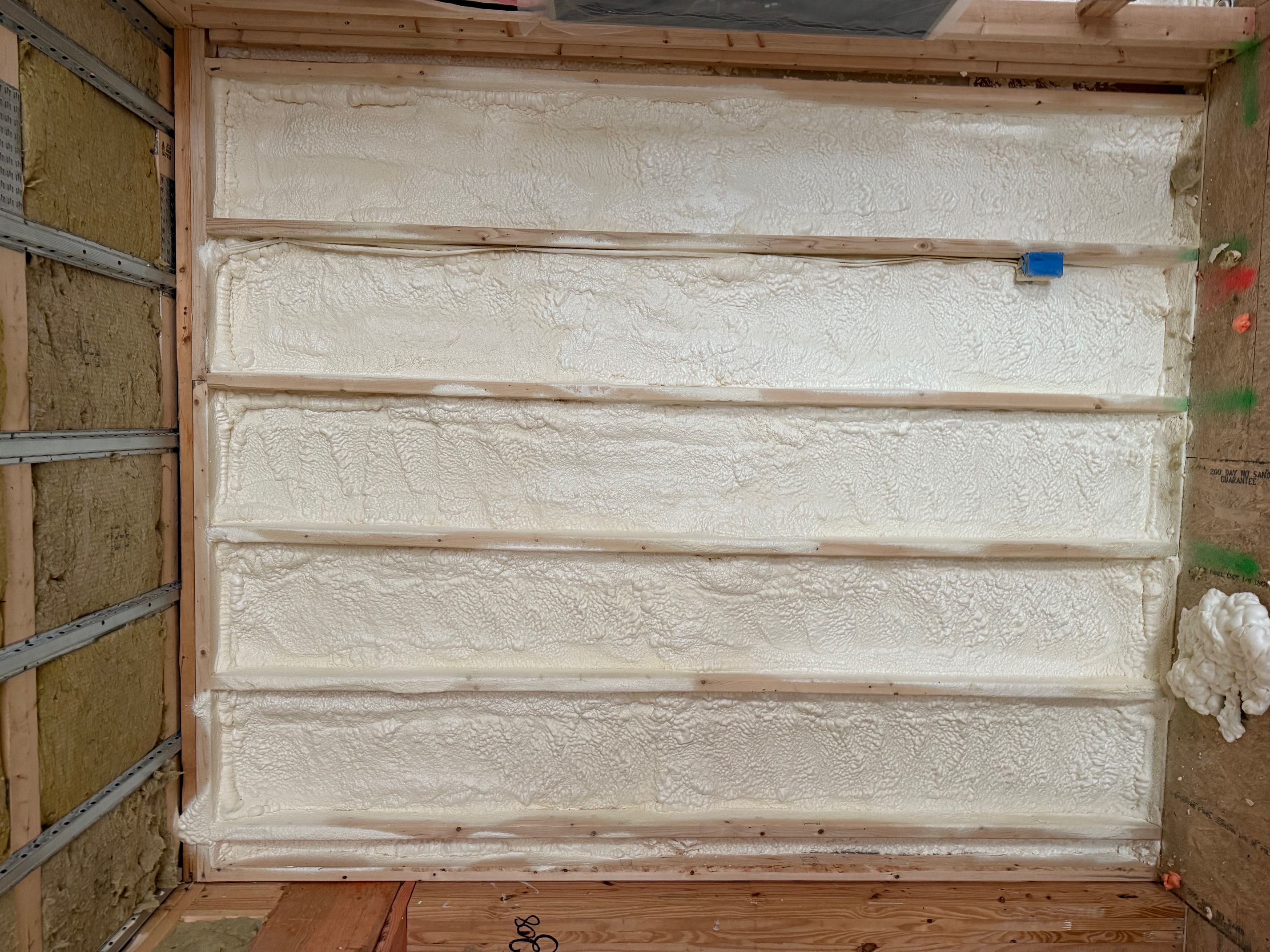 Closed-cell spray foam filling wall stud cavities for air sealing in Danvers, MA