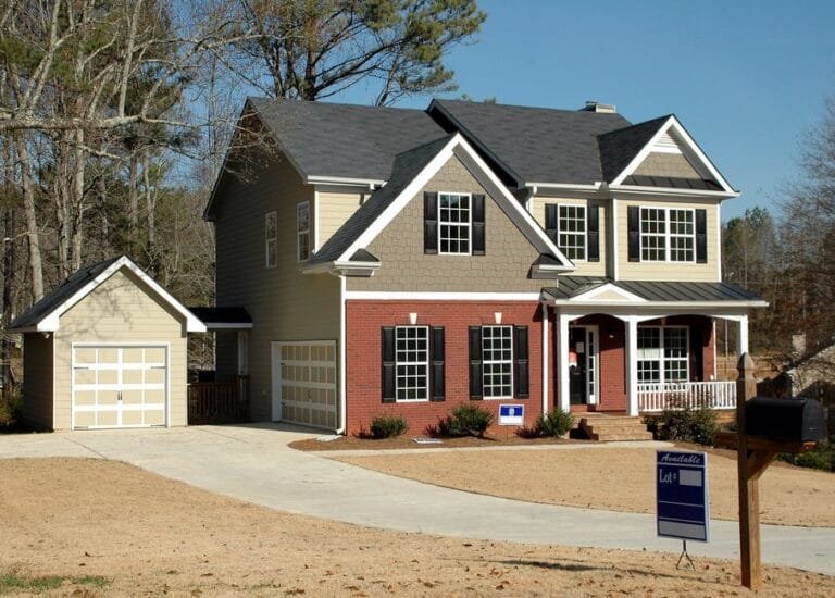 Two-story colonial with brick front, gabled roof and detached garage - HERS rating in Springfield, MA