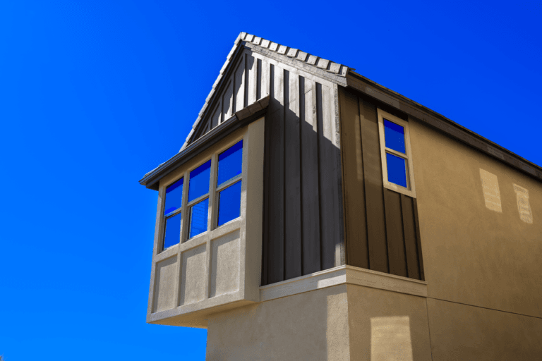 Dark board-and-batten siding and a bay window on a new home's upper floor - HERS rating in Braintree, MA