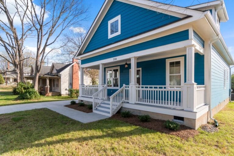 Blue craftsman bungalow with a white front porch and railing - HERS rating in Hinsdale, MA