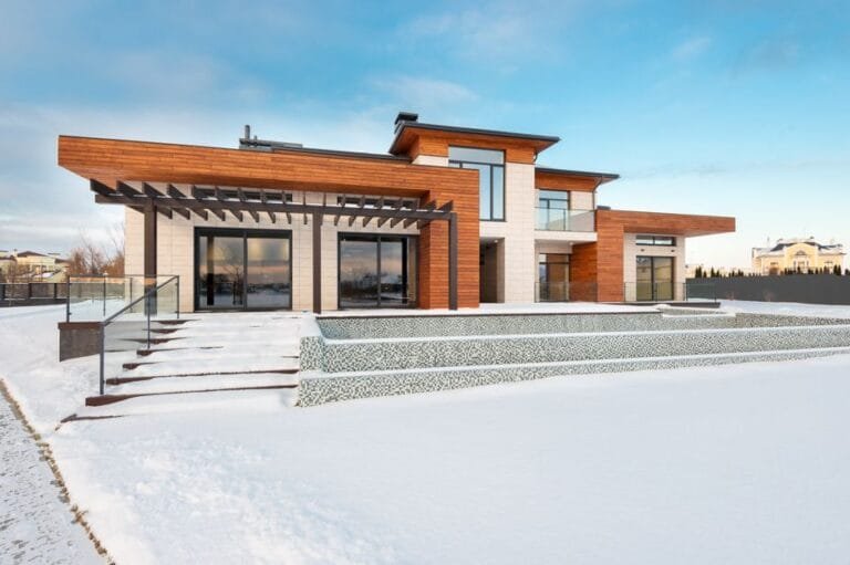 Modern single-story home with wood soffits on a snowy lot - HERS rating in Great Barrington, MA
