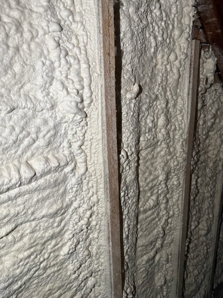 Textured spray foam sealing a framing joint up close - HERS rating in Hopedale, MA