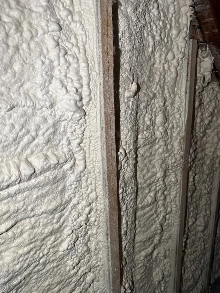 Textured spray foam sealing a framing joint up close - HERS rating in Hopedale, MA