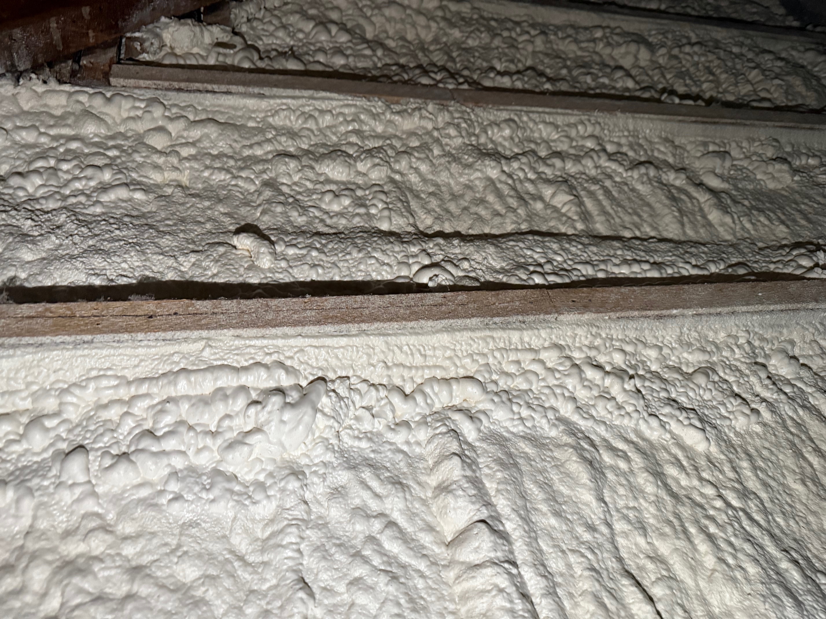 Spray foam insulation air sealing detail at wall framing in Maynard, MA