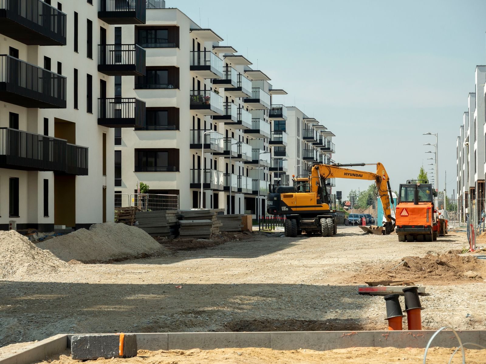 Multifamily complex under construction with sitework underway - Phius Passive House verification in Cambridge, MA