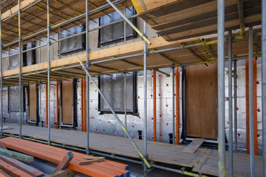 Exterior insulation boards on a multifamily wall behind scaffolding - HERS rating in Deerfield, MA