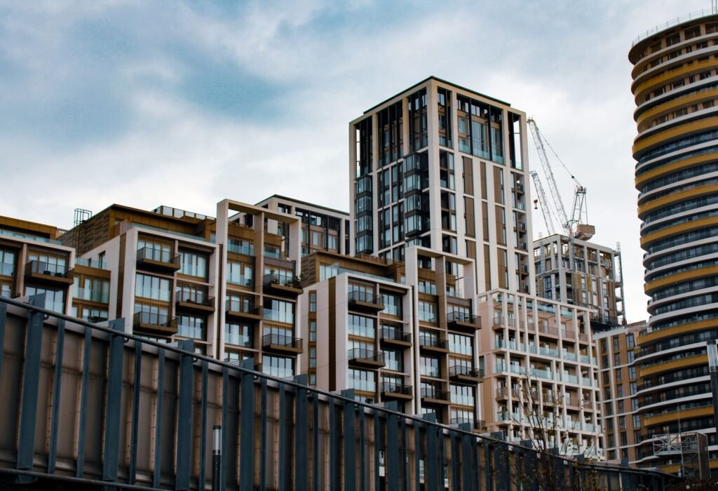 Modern high-rise apartment towers with balconies and a construction crane - HERS rating in Medway, MA