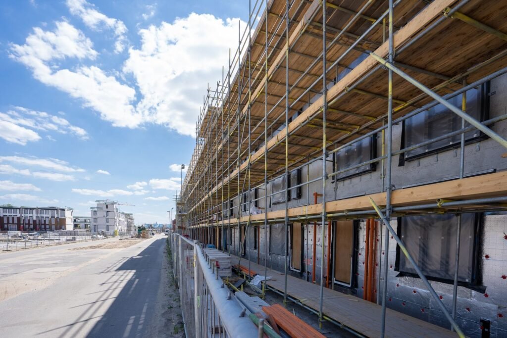 Scaffolding along a multifamily building as exterior insulation goes on - HERS rating in Lakeville, MA