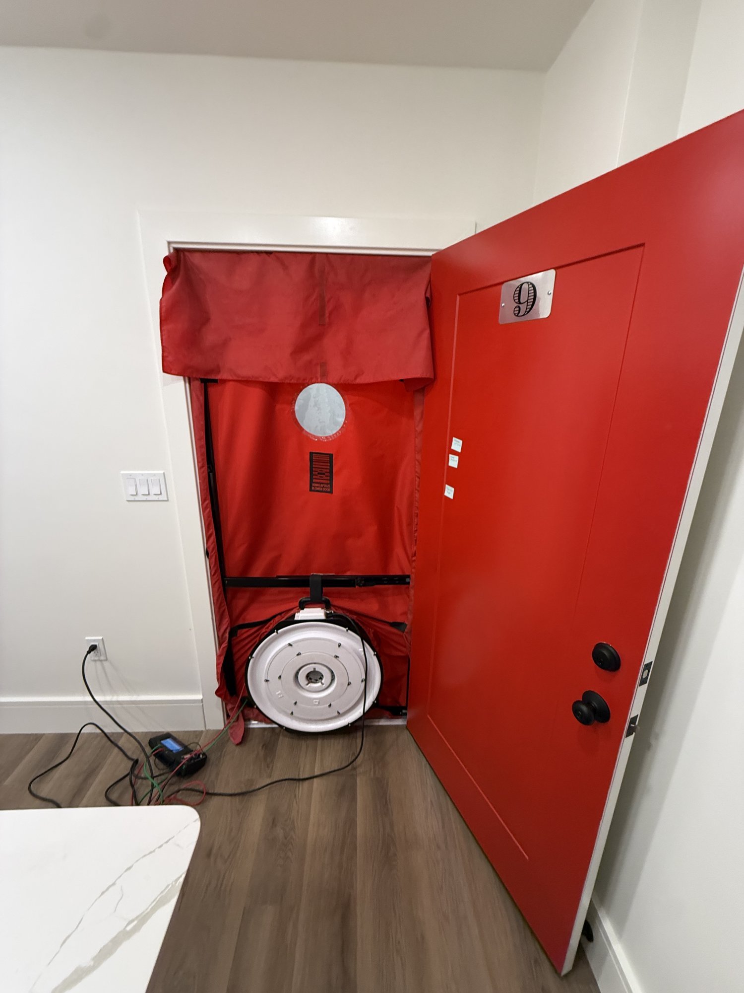 Blower door test on a multifamily unit during Phius Passive House and ENERGY STAR verification in Massachusetts