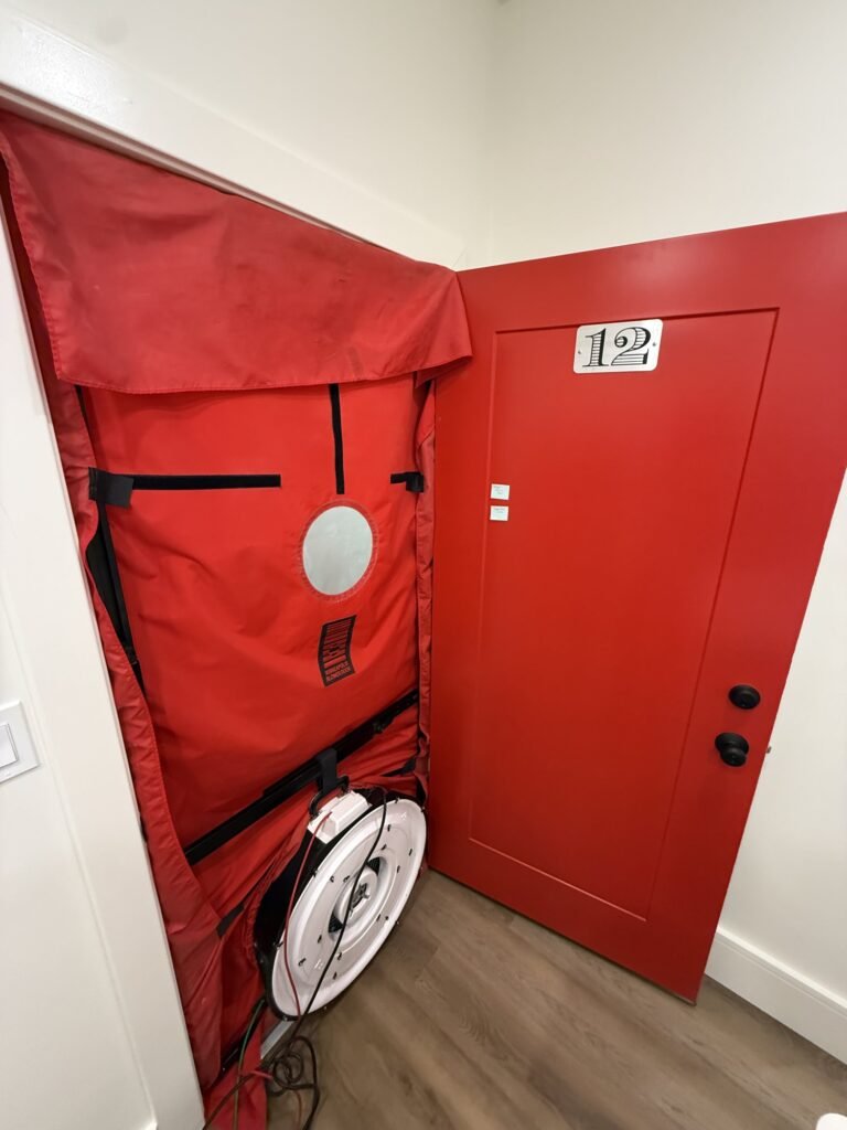 Blower door shroud and fan in an apartment door during ENERGY STAR multifamily testing – HEEC blower door testing for Melrose, MA homes