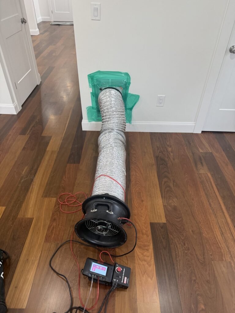 Flex duct taped to a sealed floor register leading to a test fan - HERS rating in Chilmark, MA