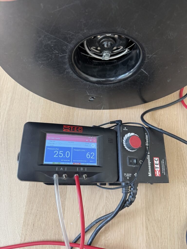Duct Blaster gauge at 25 Pa test pressure reading 62 CFM25 of total duct leakage with pressure tubes connected to channels A and B – HEEC duct leakage testing for Hatfield, MA homes