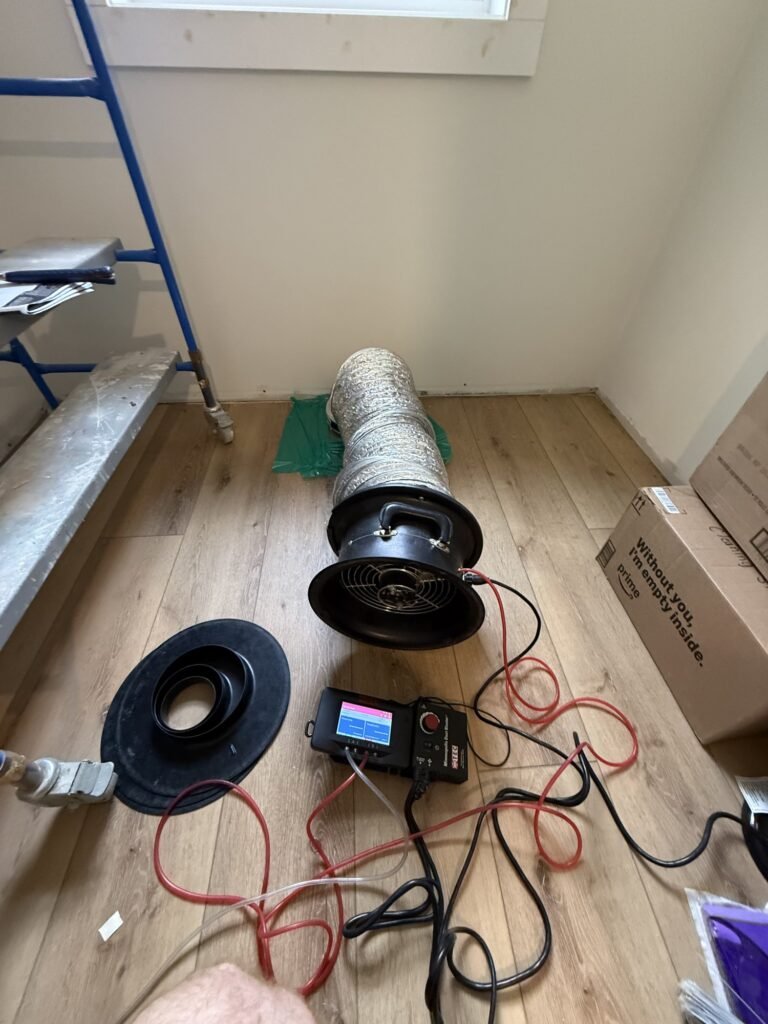Duct test fan and flex duct set up on a new wood floor - HERS rating in Heath, MA