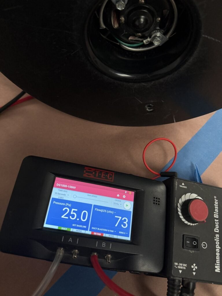 Duct Blaster gauge at 25 Pa test pressure reading 73 CFM25 of total duct leakage with the fan flow ring installed – HEEC duct leakage testing for Brookfield, MA homes