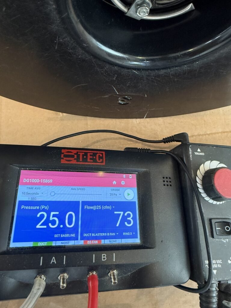 Duct Blaster gauge at 25 Pa test pressure reading 73 CFM25 of total duct leakage with the controller knob visible – HEEC duct leakage testing for Sherborn, MA homes