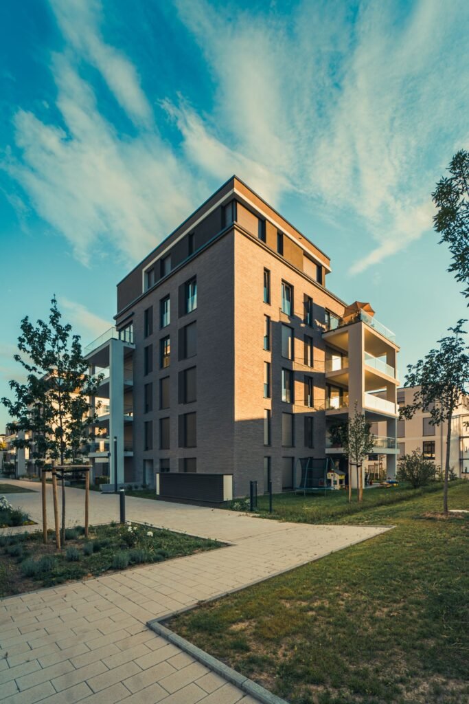 Contemporary apartment building with balconies beside a landscaped walkway - HERS rating in Marion, MA