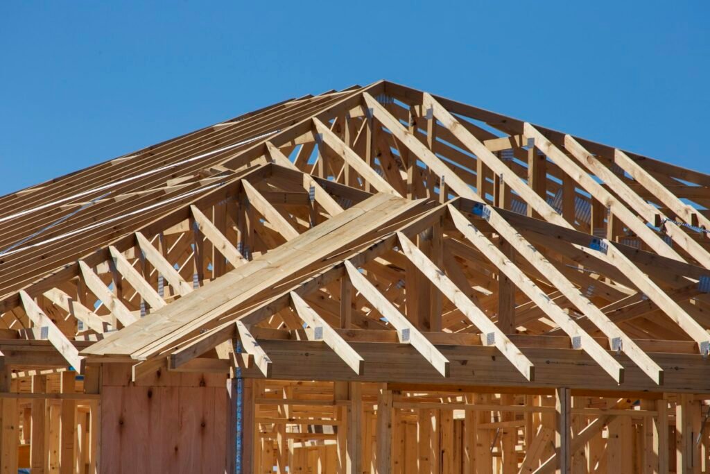 Roof trusses set on a new home against a clear blue sky - HERS rating in Hingham, MA