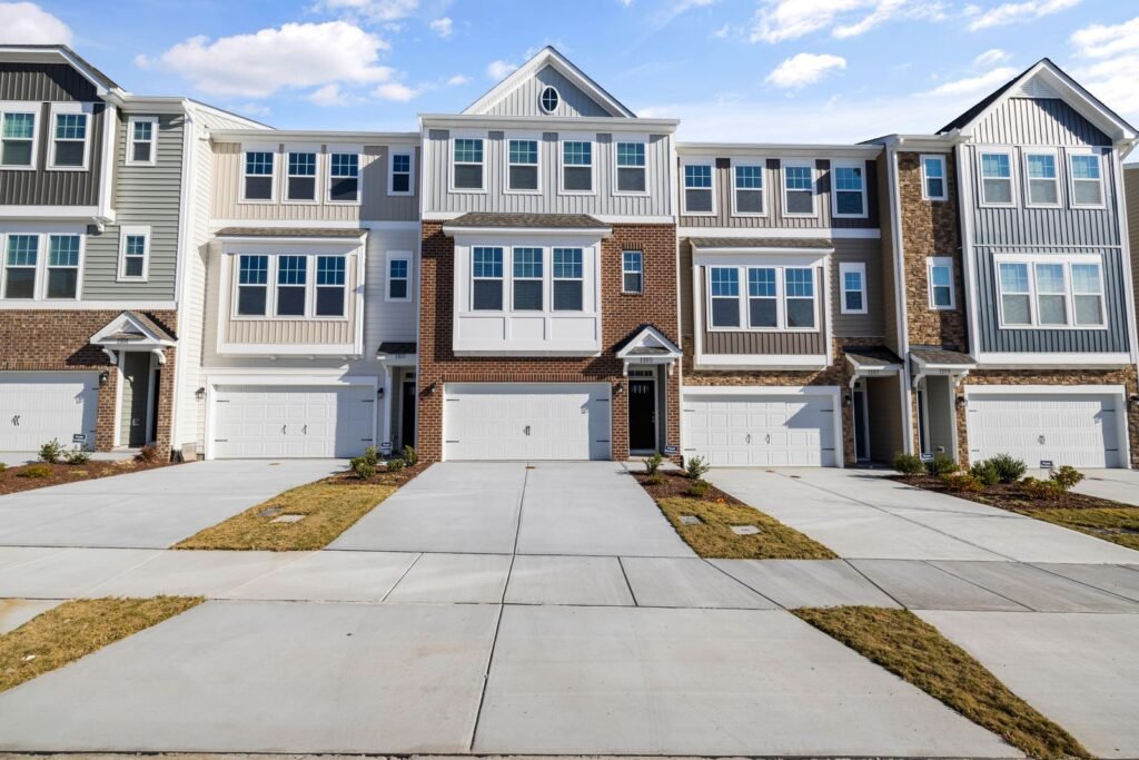 New three-story townhouses with front garages and short driveways - HERS rating in Easthampton, MA