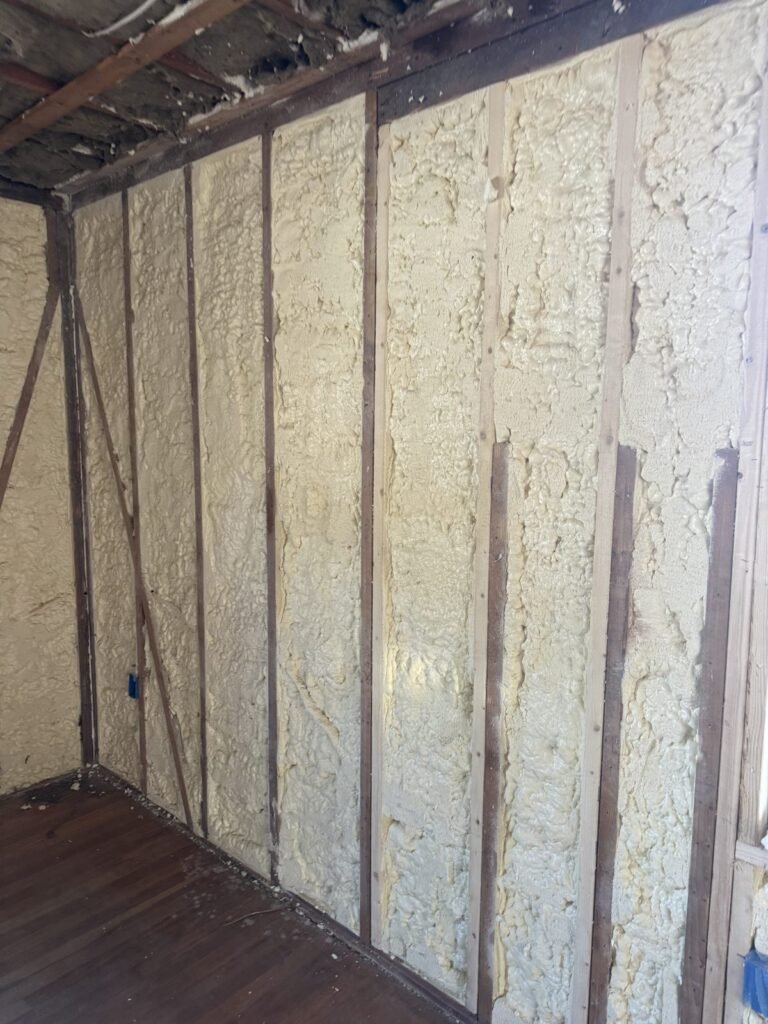 Spray foam filling the stud bays of an unfinished exterior wall - HERS rating in Chester, MA