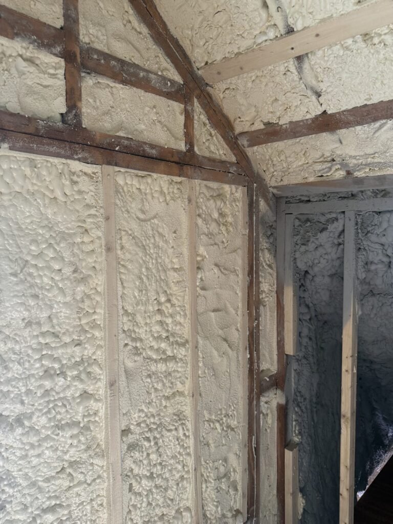 Spray-foamed attic knee wall where the roof slope meets the eaves - HERS rating in Chelsea, MA