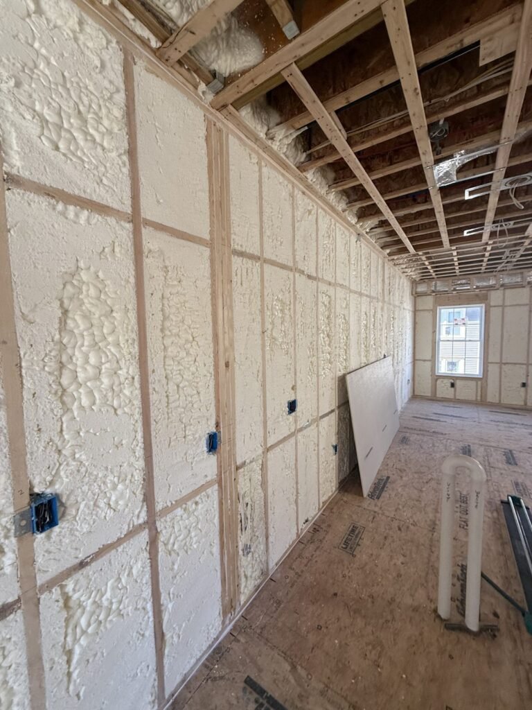 Long room with foamed exterior walls and open ceiling joists - HERS rating in Douglas, MA