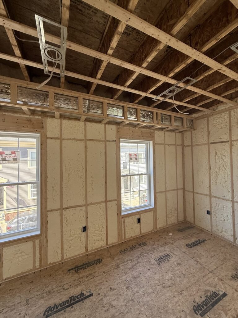 Foam-insulated walls with two double-hung windows and open ceiling joists - HERS rating in Ayer, MA