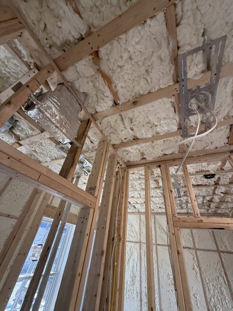 Spray-foamed ceiling bays around recessed light boxes and a duct boot - spray foam insulation in Dracut, MA