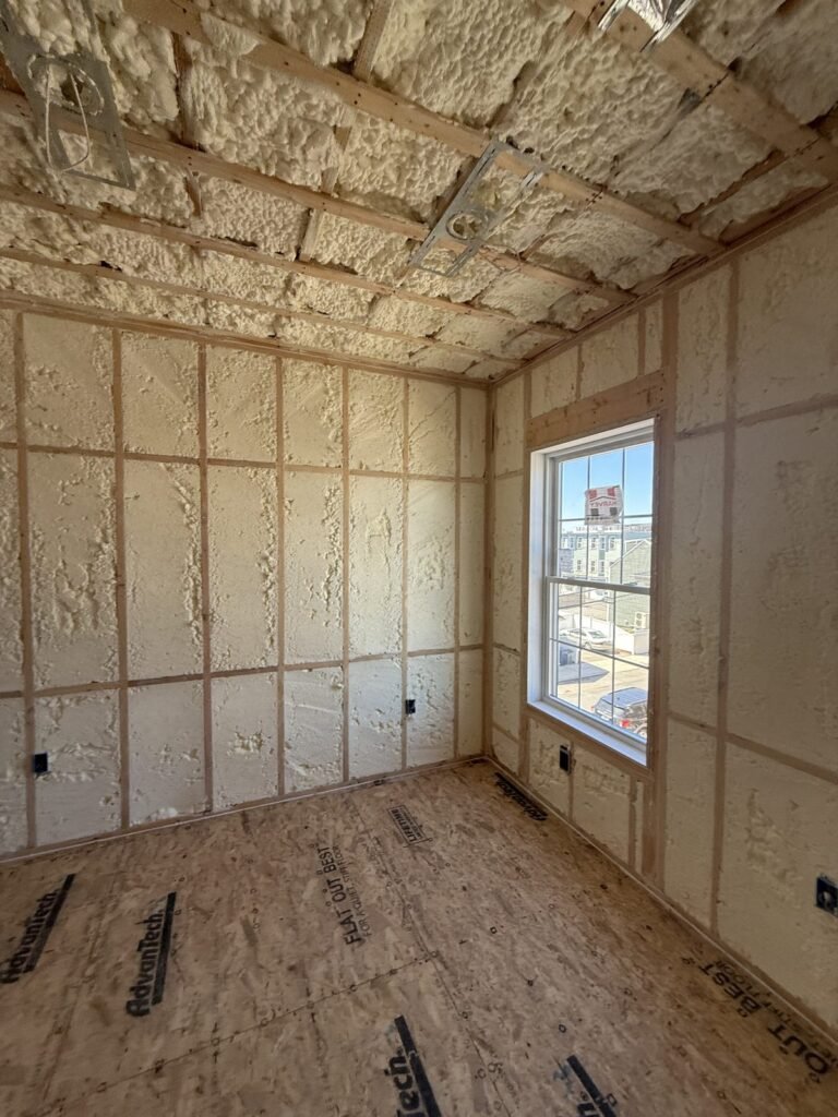 Small room with foamed walls and ceiling beside a window - HERS rating in Danvers, MA