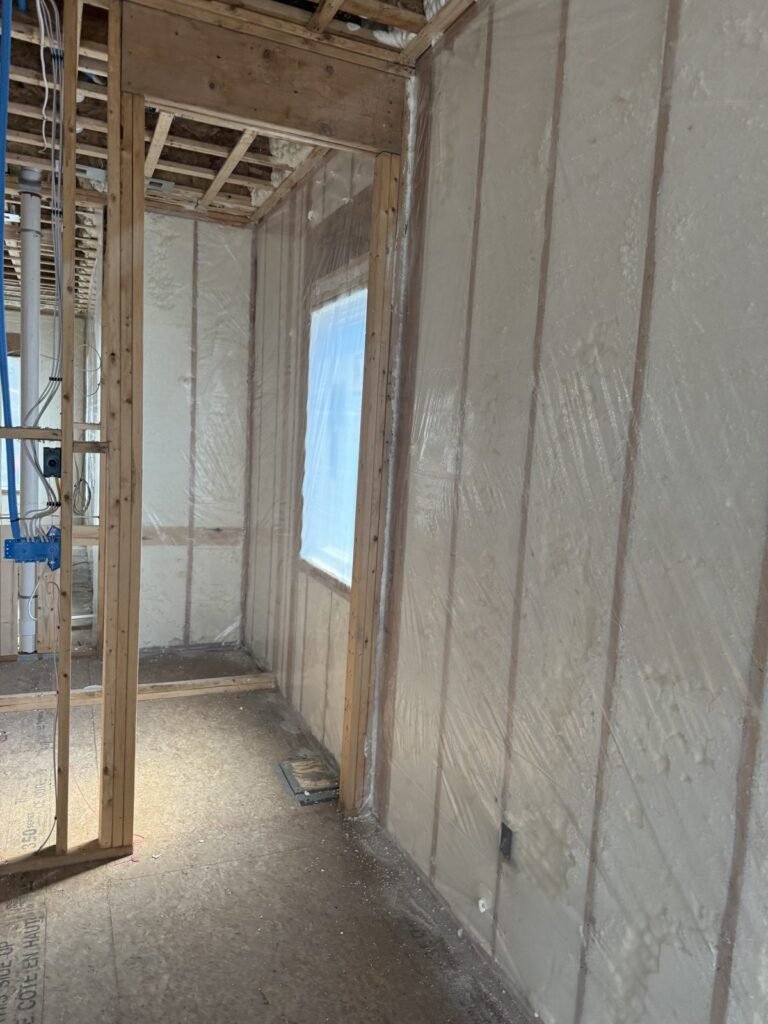 Narrow foam-insulated room with a tall window - HERS rating in Bernardston, MA