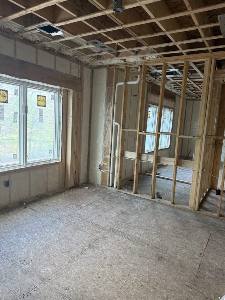 Spray-foamed exterior walls around a wide picture window in a framed room - HERS rating in Needham, MA