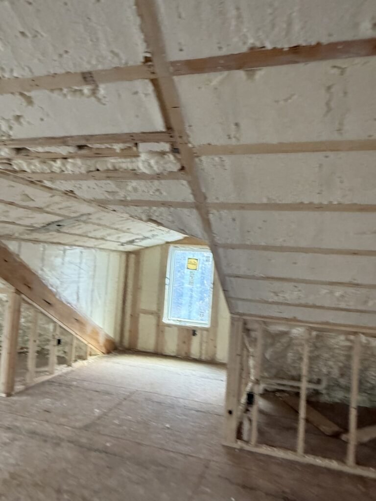 Spray-foamed attic roof slope over a framed dormer with a window - HERS rating in Holyoke, MA