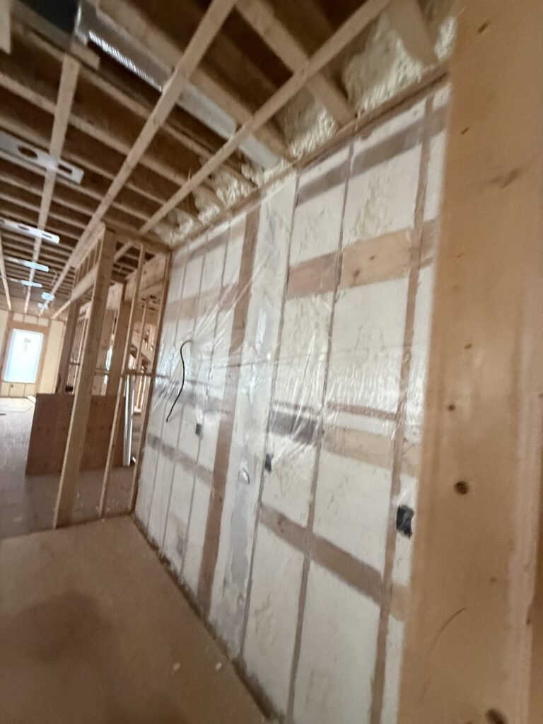 Spray-foamed exterior wall along an open floor during a renovation - HERS rating in Newbury, MA
