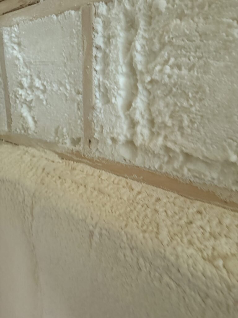 Close-up of a cured spray foam surface on a wall - HERS rating in Adams, MA