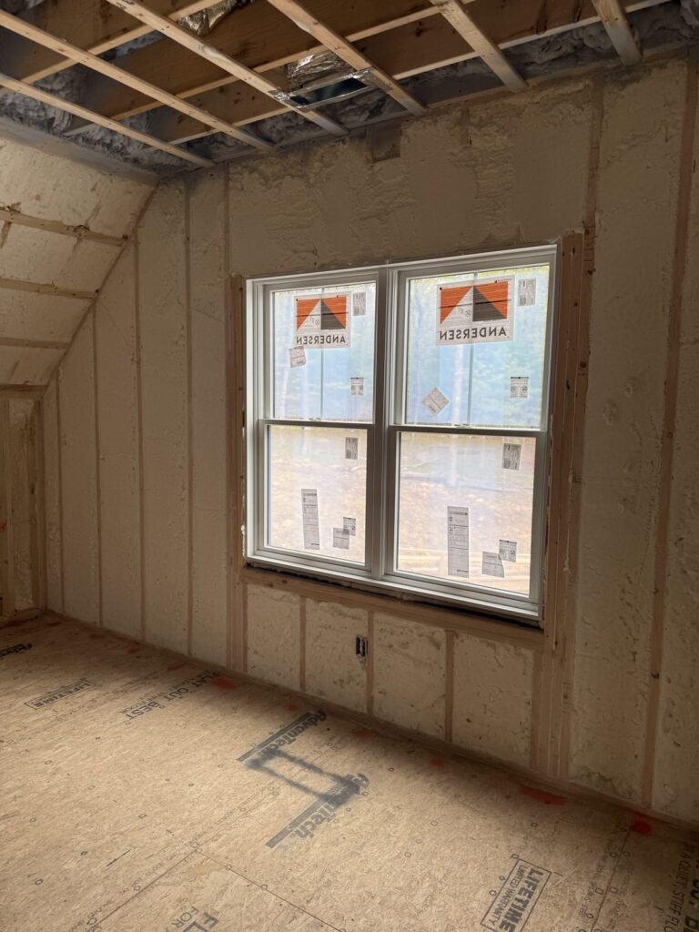 Spray-foamed bedroom walls around a double window - spray foam insulation in Monroe, MA