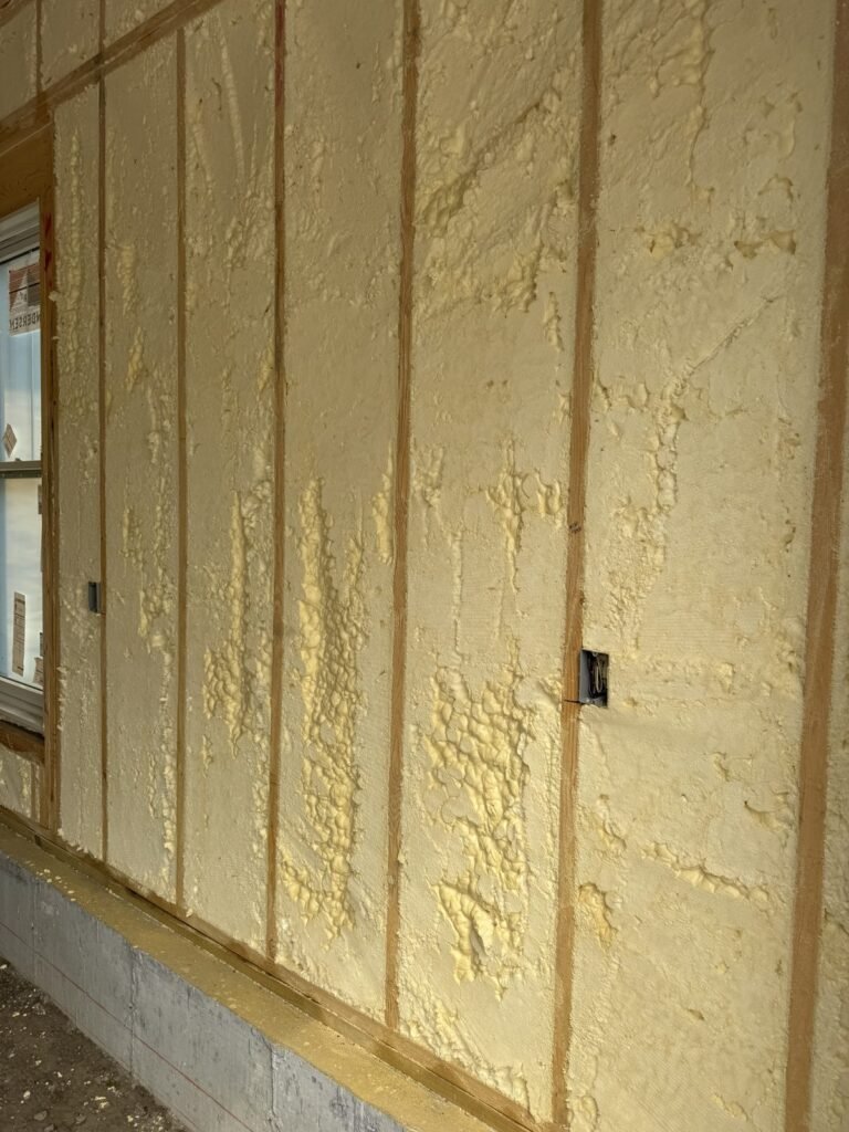 Foundation-level exterior wall fully sprayed with foam above the concrete - spray foam insulation in Reading, MA