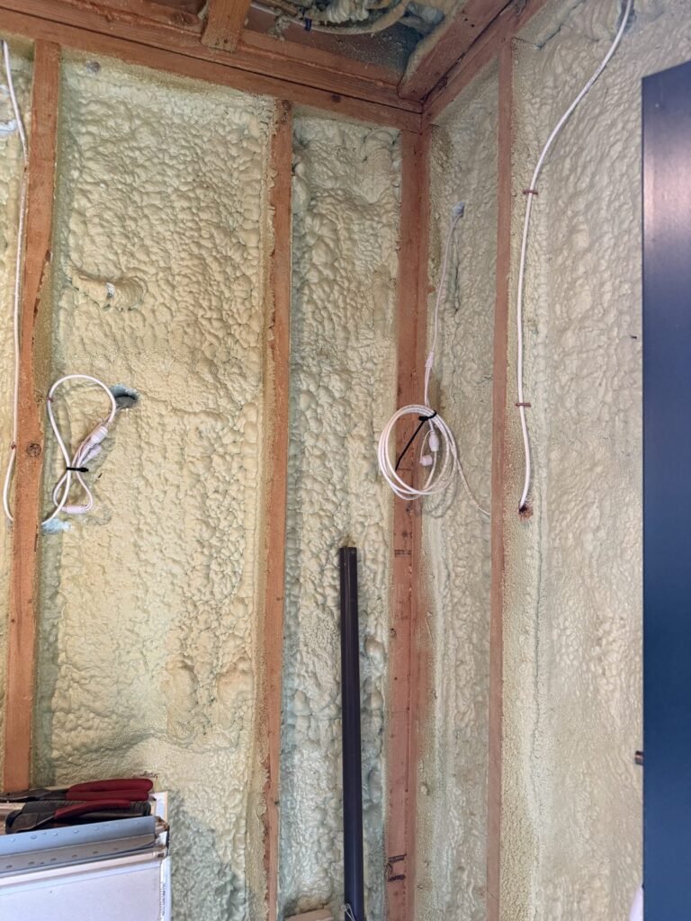Yellow spray foam in wall bays around wiring and electrical boxes - spray foam insulation in Ware, MA