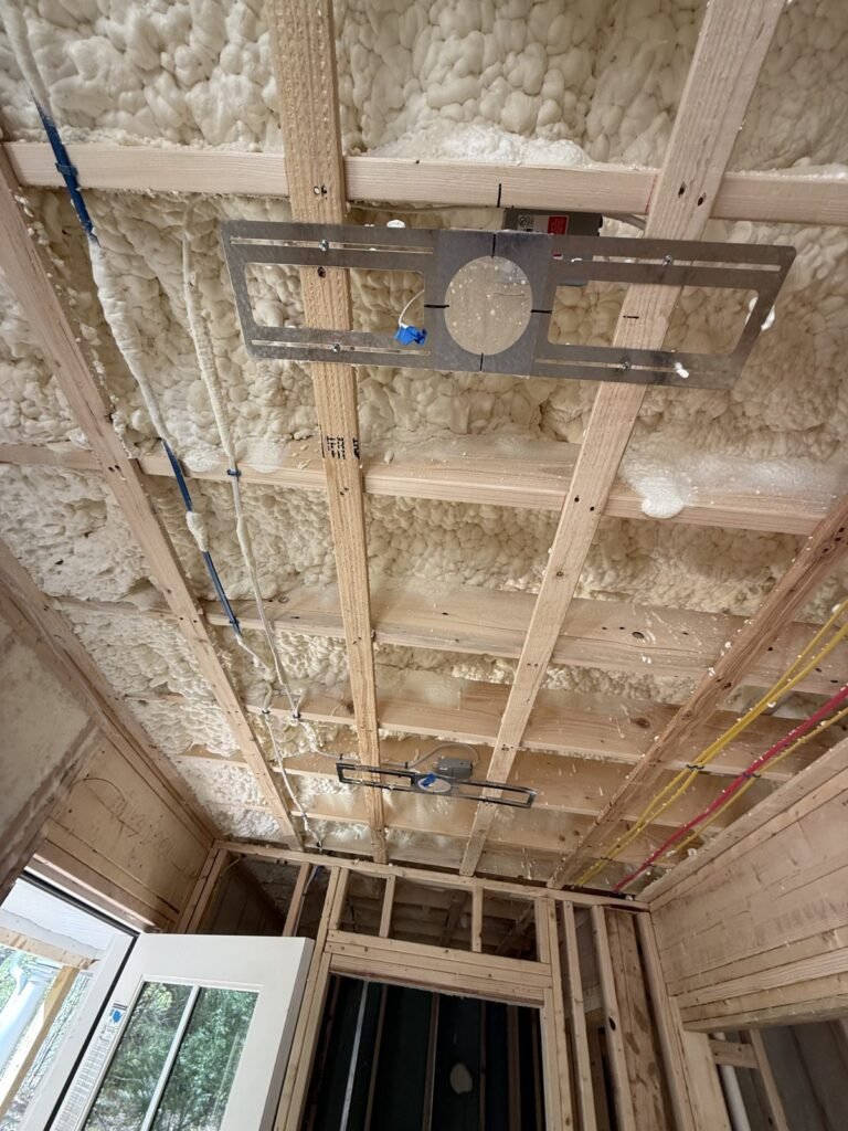 Spray foam filling ceiling joist bays above strapping in a new addition - spray foam insulation in Framingham, MA