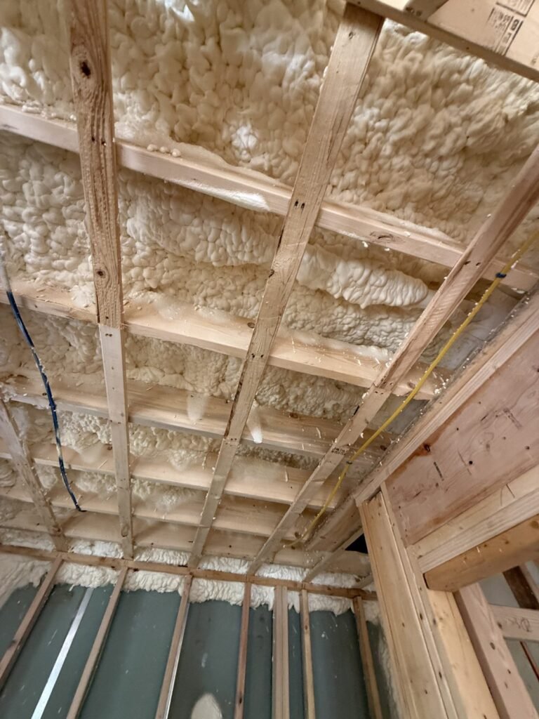 Thick spray-foamed ceiling above wood strapping with wiring run through - HERS rating in Andover, MA