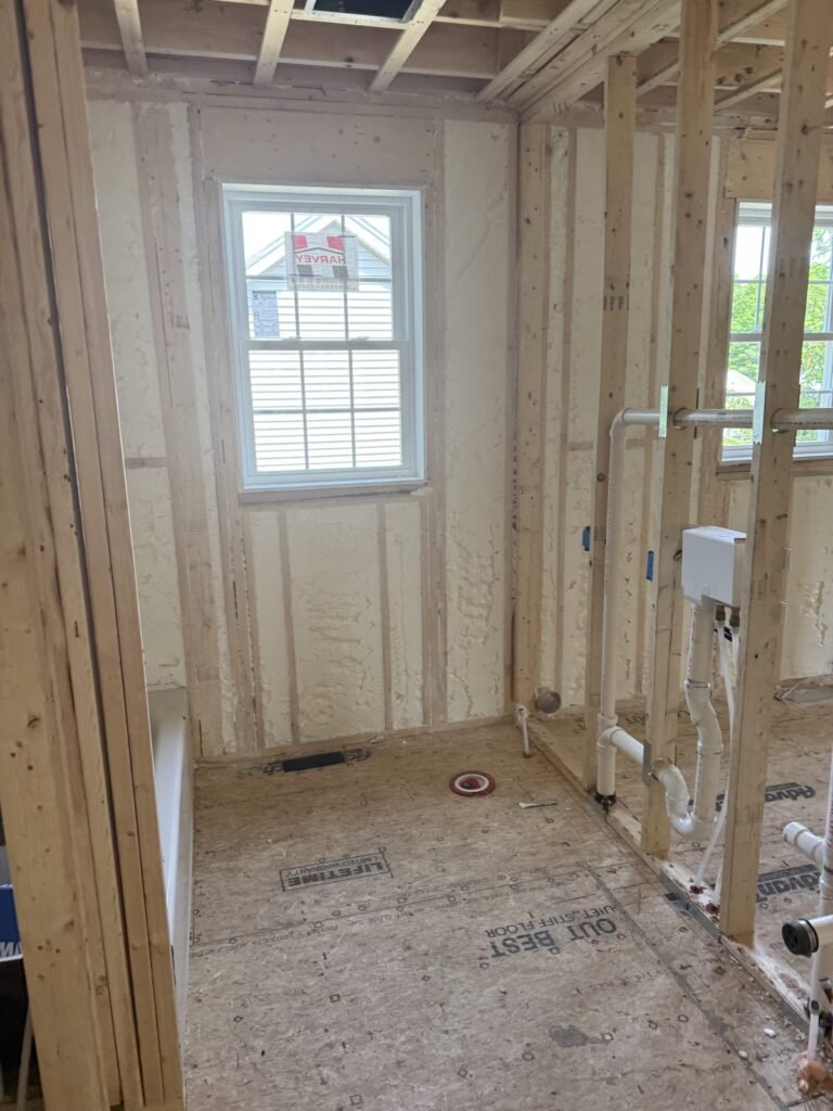 Spray-foamed walls in an open-stud bathroom rough-in with a window - HERS rating in Lowell, MA