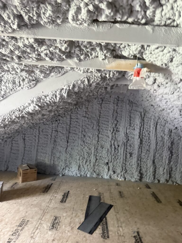 Attic with spray foam on the roof deck and gable end above a plywood floor - spray foam insulation in Stoneham, MA