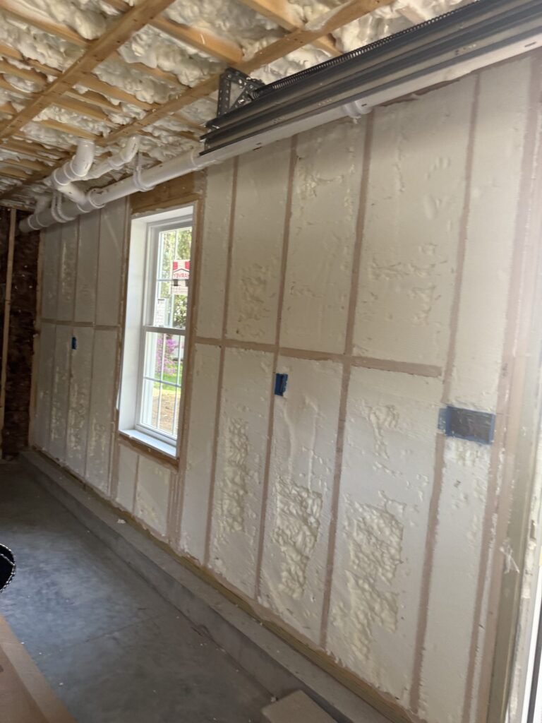 Foamed exterior wall with a window and electrical box - HERS rating in Bedford, MA