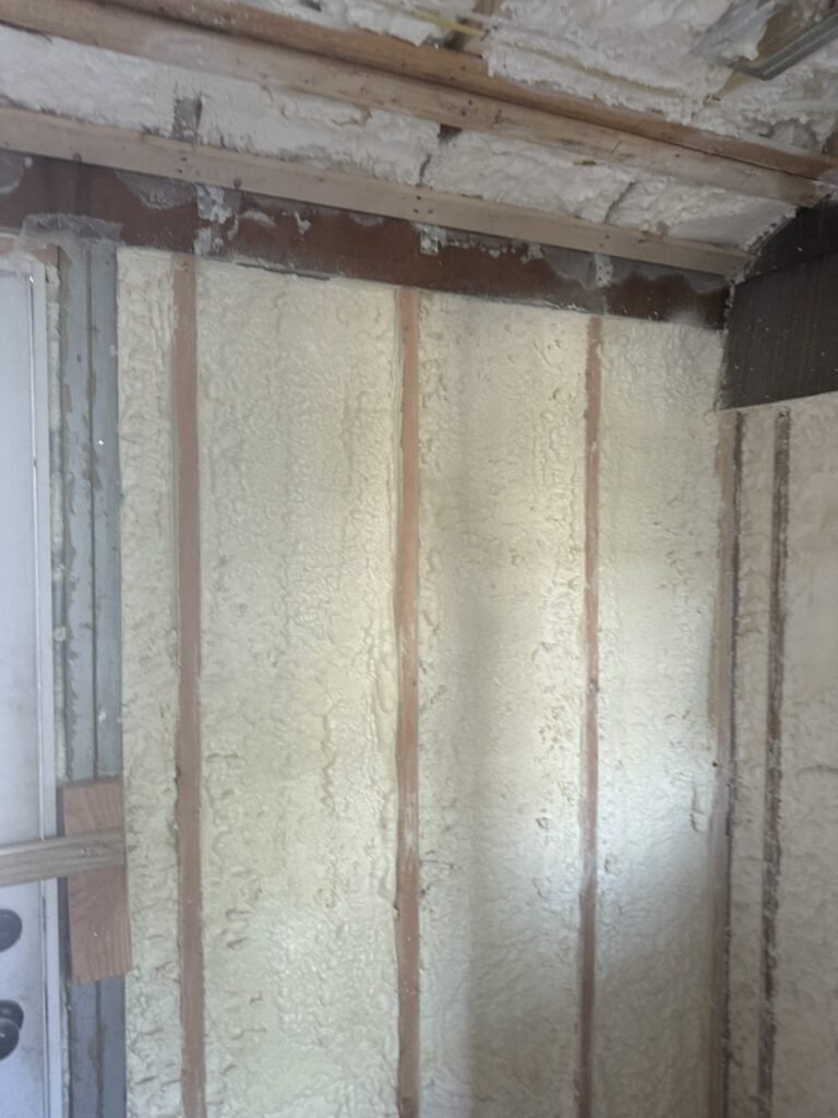 Stud bays filled with spray foam along a wall up to the ceiling - spray foam insulation in Lee, MA
