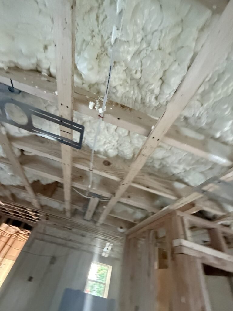 Roof framing sealed with spray foam around a recessed light - HERS rating in Berlin, MA