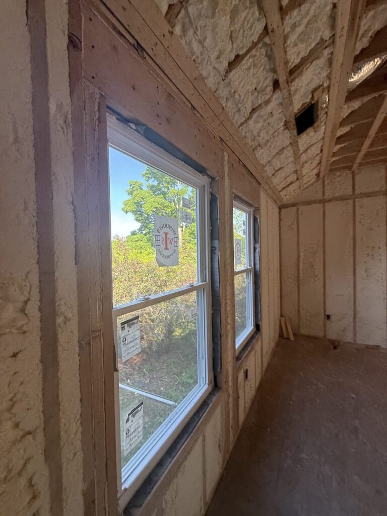Spray-foamed sloped ceiling and walls around new windows on an upper floor - HERS rating in Leominster, MA