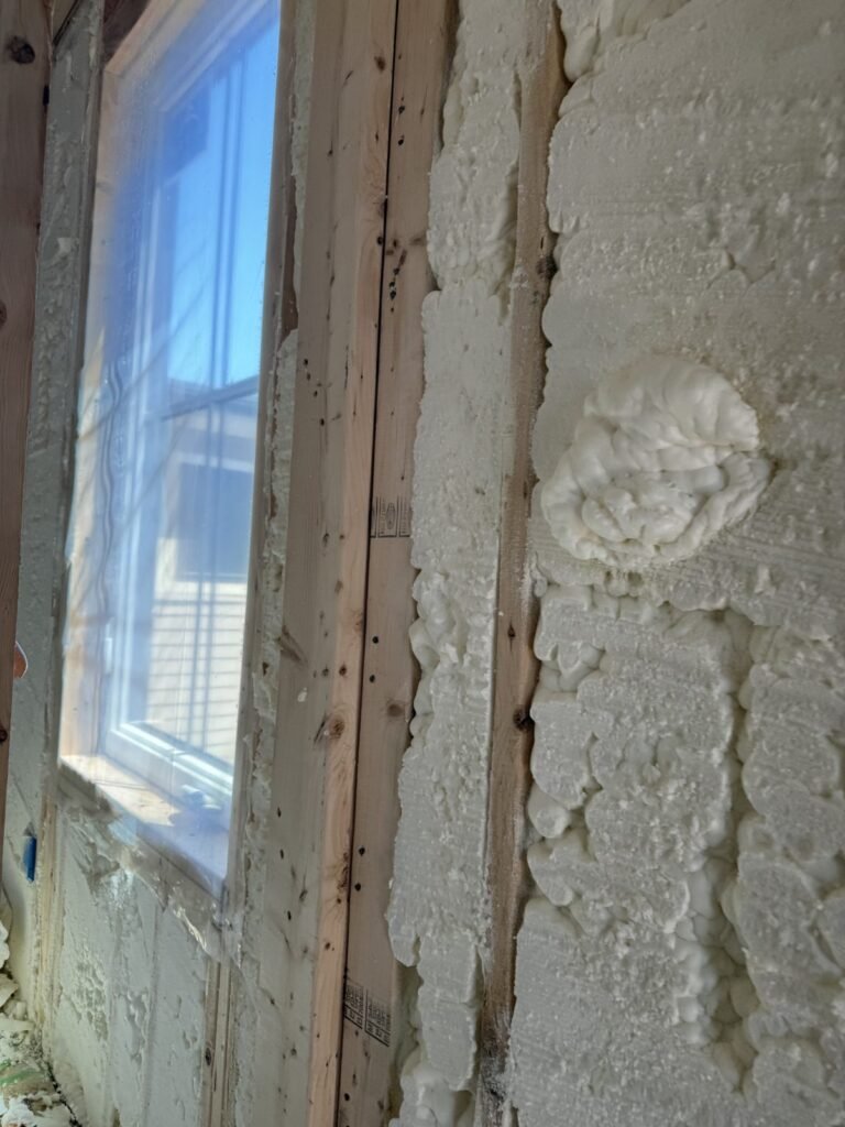Spray foam sealed around the edge of a window frame - HERS rating in Maynard, MA