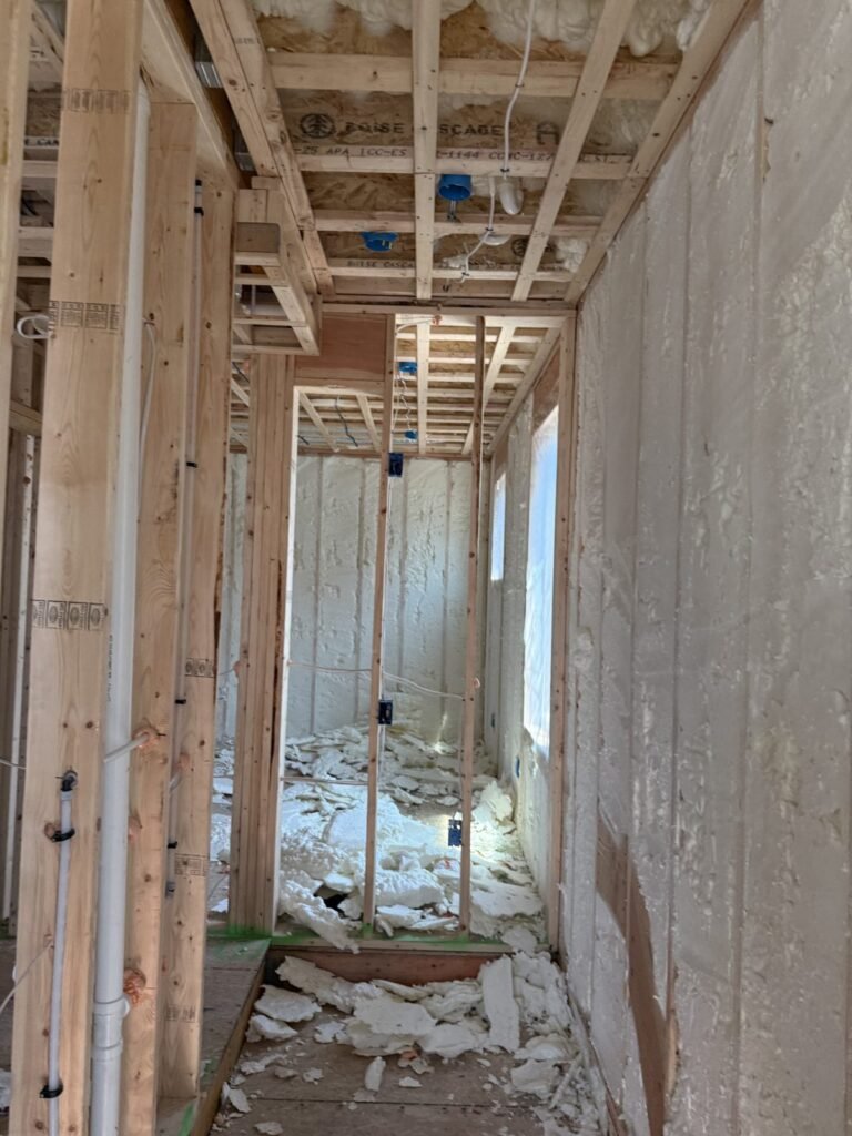 Narrow framed hallway with spray-foamed walls and foam trimmings on the floor - HERS rating in Leyden, MA