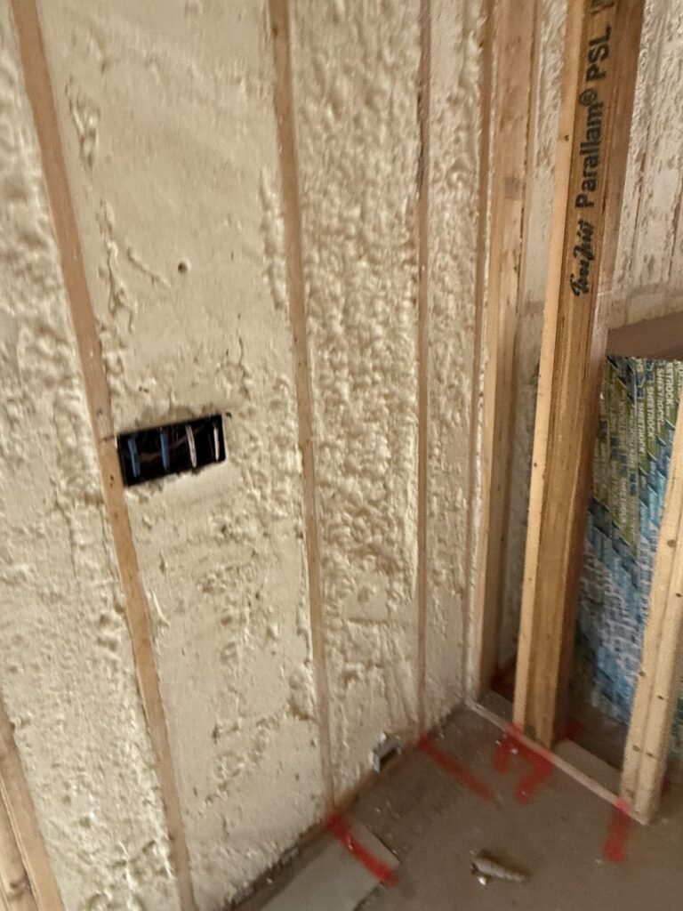 Spray foam sealed around a switch box next to a window rough opening - HERS rating in New Ashford, MA